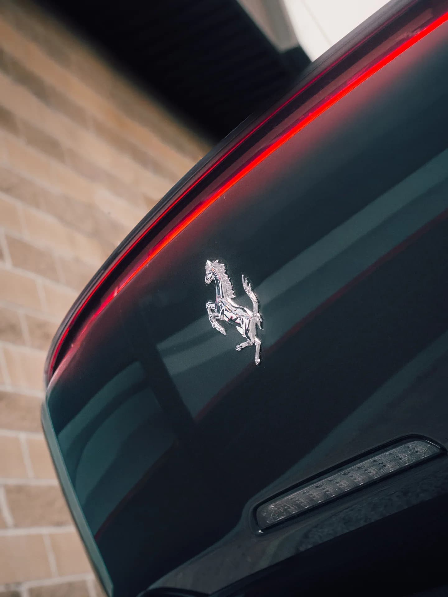 Chrome prancing horse emblem on black Ferrari Monza SP2 rear
