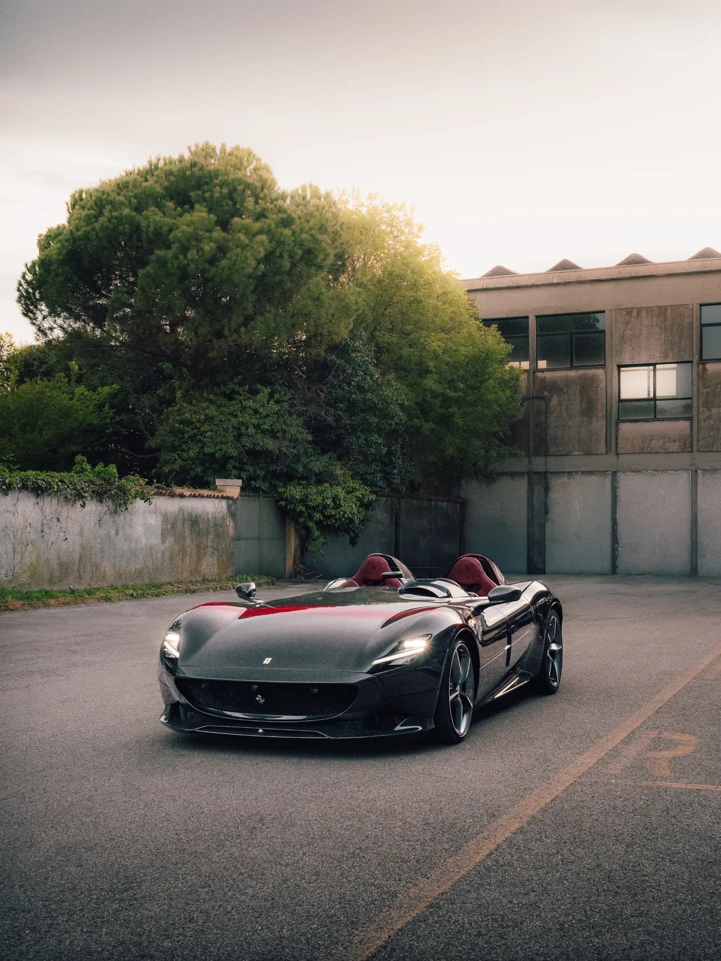 Ferrari Monza SP2 barchetta on open road at golden hour